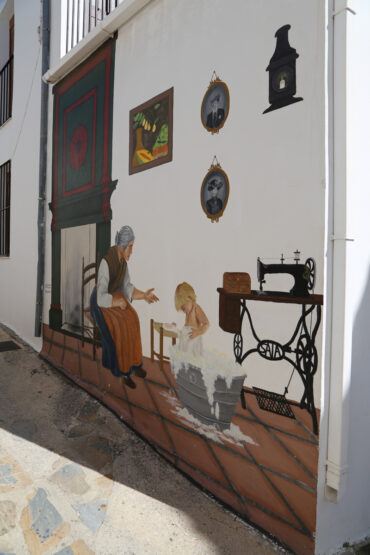 Mural de una abuela bañando al nieto